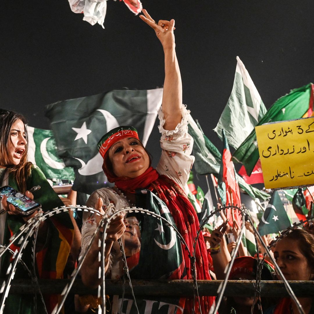 Supporters of former Prime Minister Imran Khan's party, Pakistan Tehreek-e-Insaf (PTI), are seen at a rally in Lahore, Pakistan, on April 21, 2022.