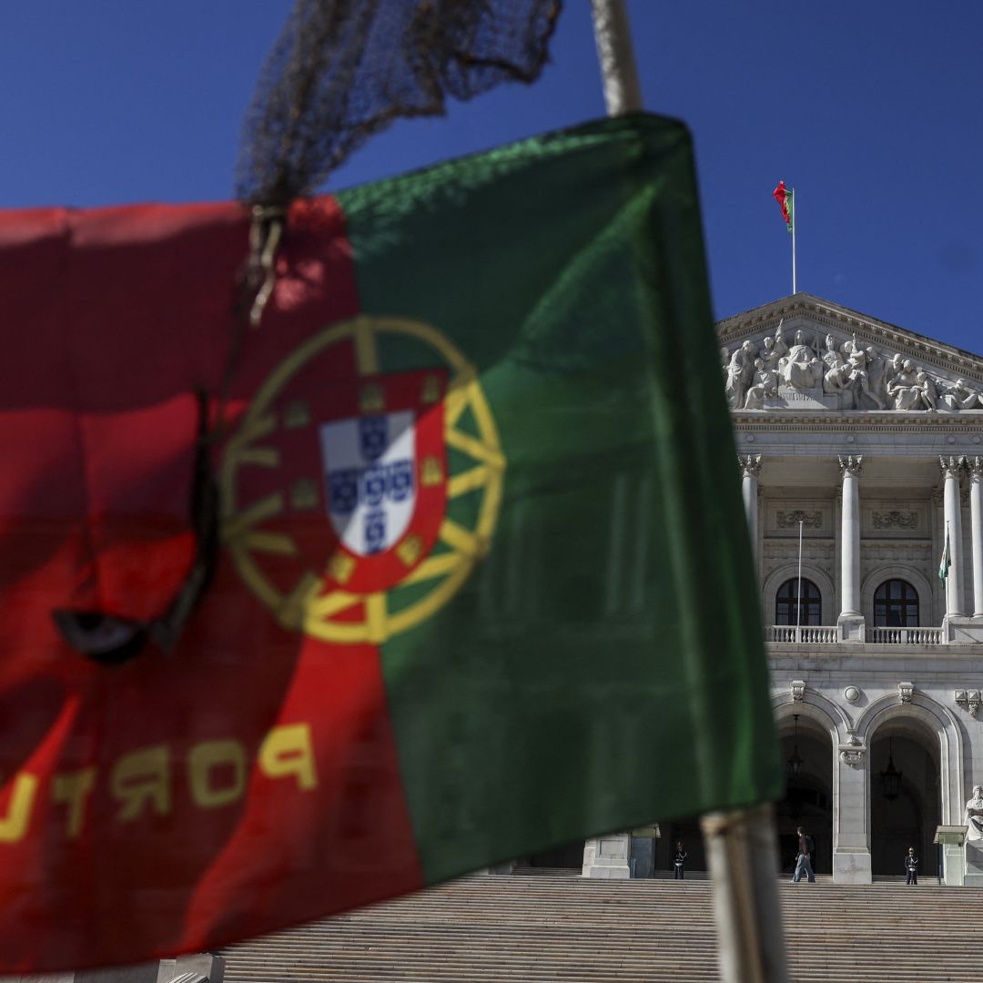 A Portuguese flag flies in front of the parliament in Lisbon on Nov. 7, 2023, after Prime Minister Antonio Costa announced he would resign as head of state in the wake of a corruption scandal involving energy contracts.