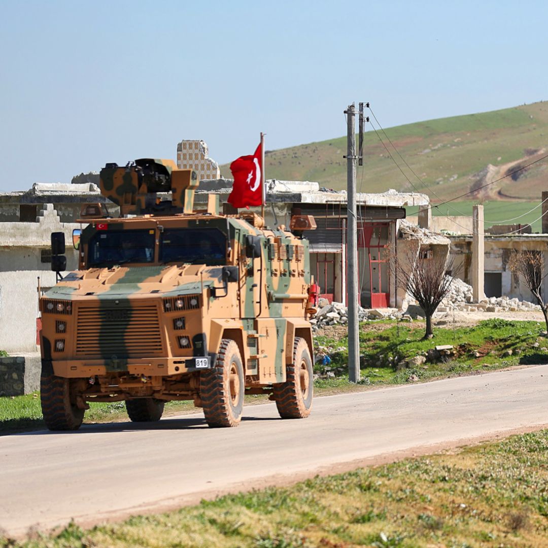 A column of armored Turkish military vehicles proceeds along a road in a demilitarized zone in the western countryside of Syria's Aleppo province on March 8, 2019.