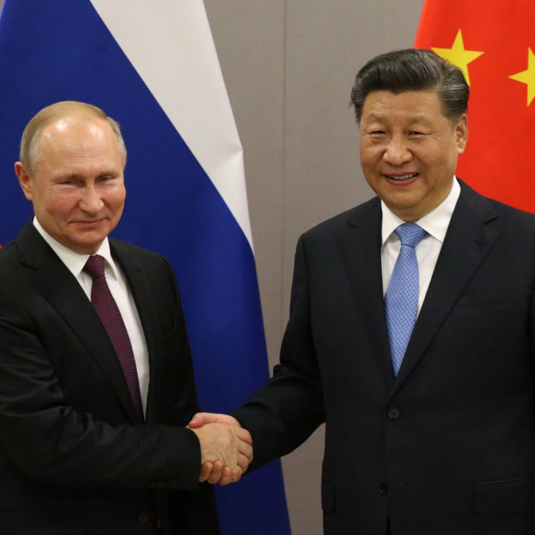 Russian President Vladimir Putin (L) greets Chinese President Xi Jinping in November 2019 in Brasilia, Brazil.