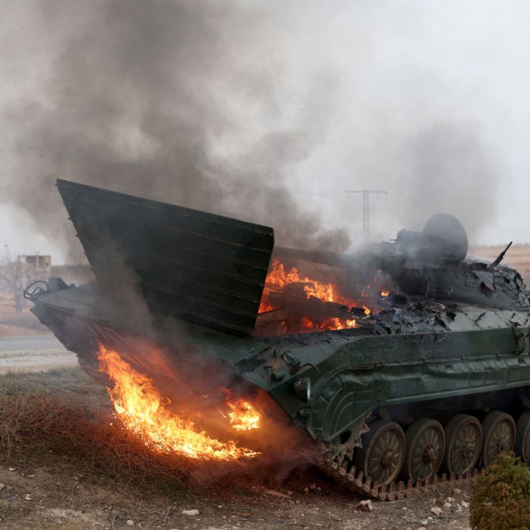 A military vehicle burns after it was hit by Syrian regime forces Dec. 7 in Syria's Hama governorate.