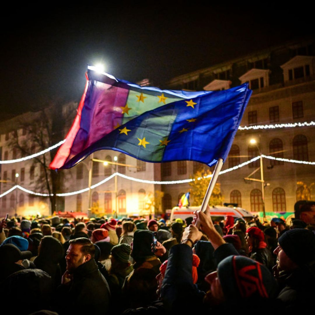 Demonstrators hold EU and Romanian national flags during a pro-European rally in support of democracy at University Square in Bucharest, Romania, on Dec. 5, 2024, a few days before key elections. 