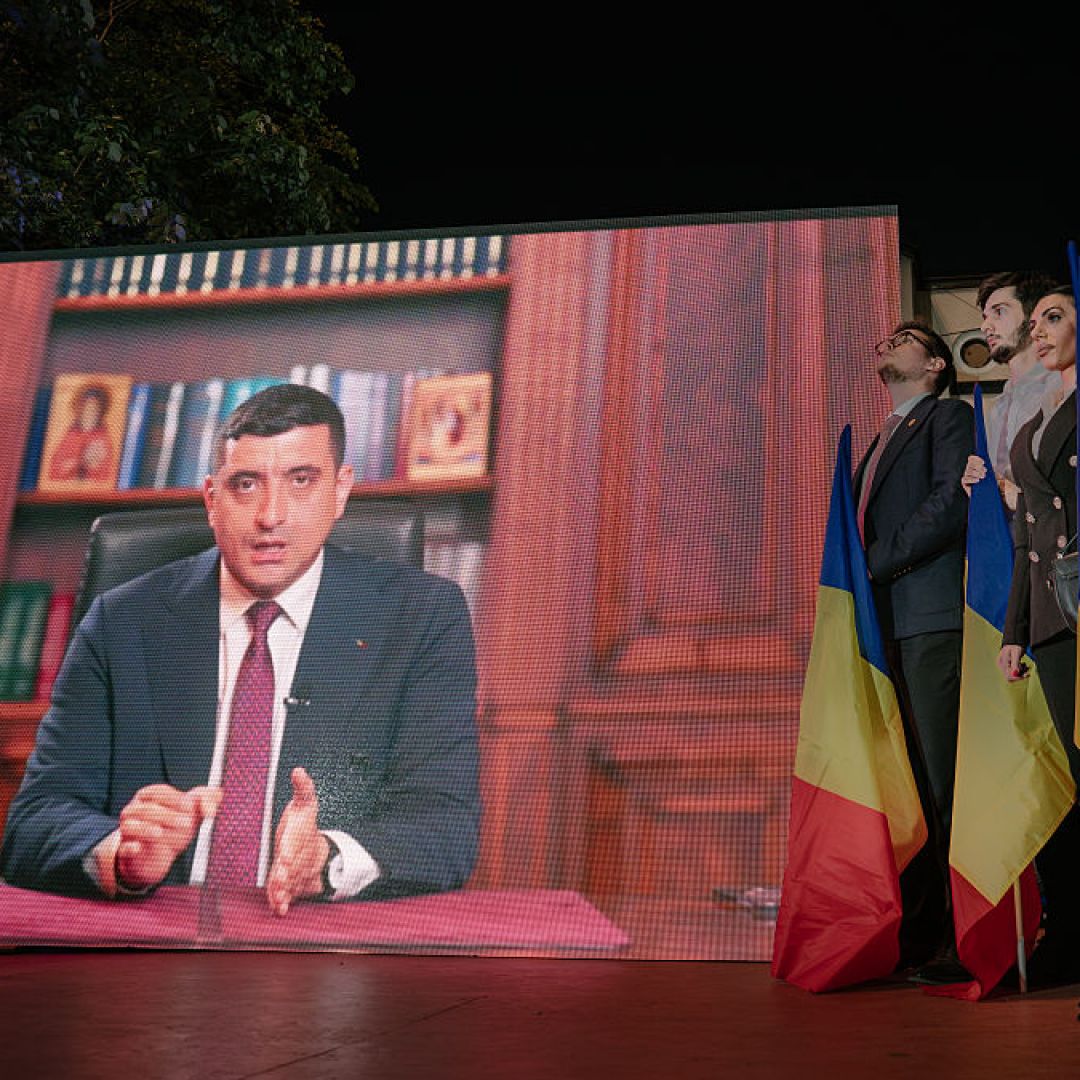 Presidential candidate George Simion is shown on a screen addressing his supporters at the campaign headquarters of their candidate after polls closed on May 4, 2025 in Bucharest, Romania. Presidential candidate George Simion is shown on a screen addressing his supporters at the campaign headquarters of their candidate after polls closed on May 4, 2025 in Bucharest, Romania.