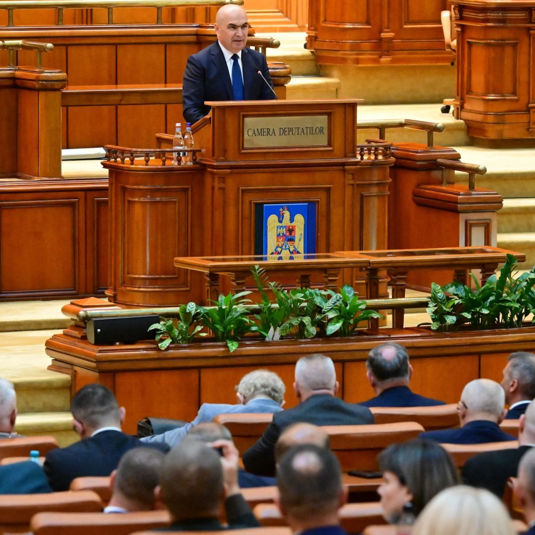 Romanian Prime Minister Ilie Bolojan delivers a speech to lawmakers in parliament in Bucharest on June 23, 2025.