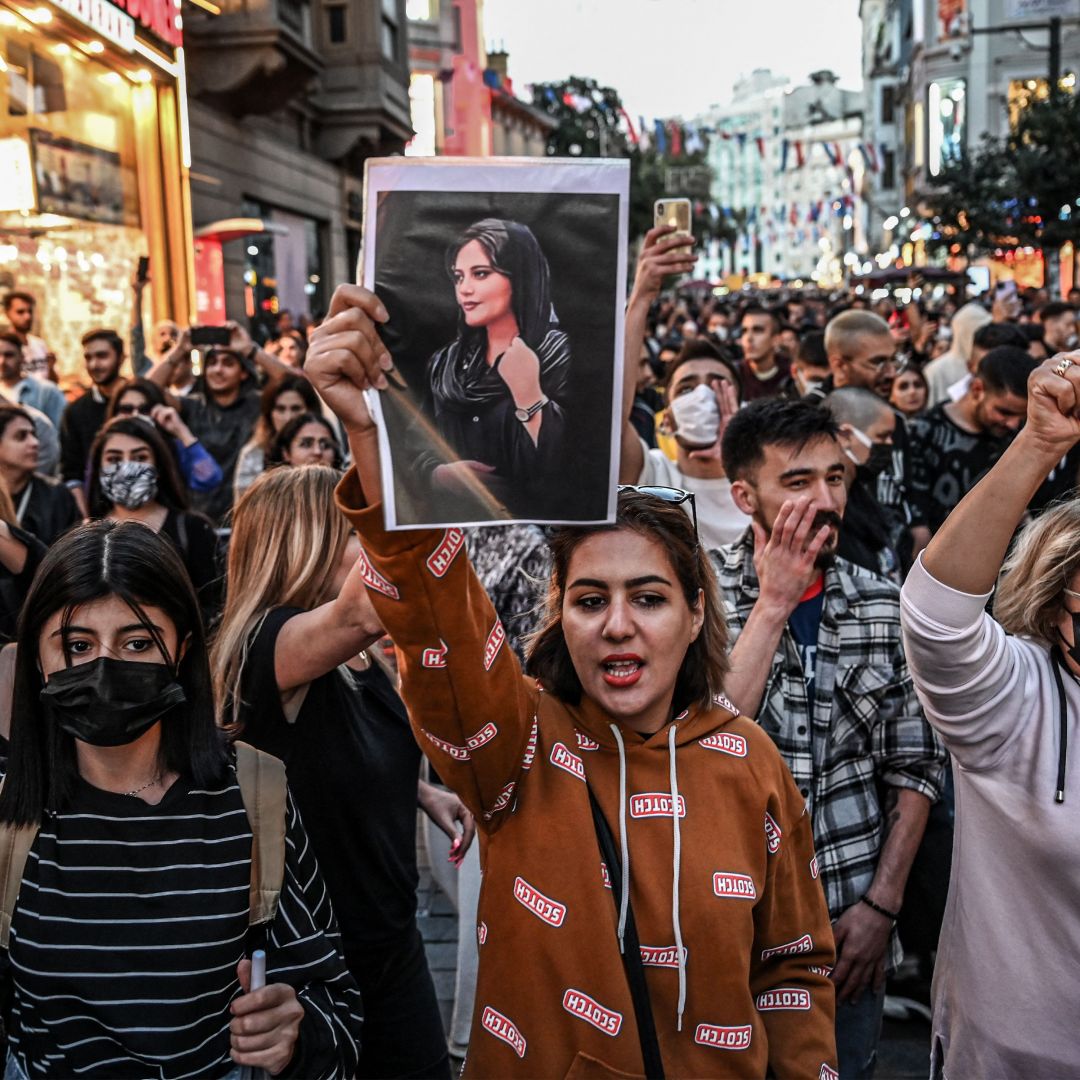 A protester in Turkey holds a portrait of Mahsa Amini during a demonstration in support of Amini, a young Iranian woman who died Sept. 16 after being arrested in the Iranian capital of Tehran by the morality police. 
