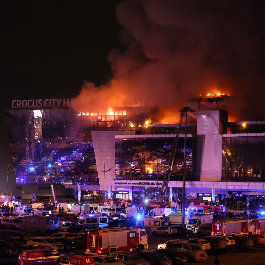 Emergency services vehicles are seen outside the burning Crocus City Hall concert hall following a shooting incident in Krasnogorsk, outside Moscow, Russia, on March 22, 2024. 