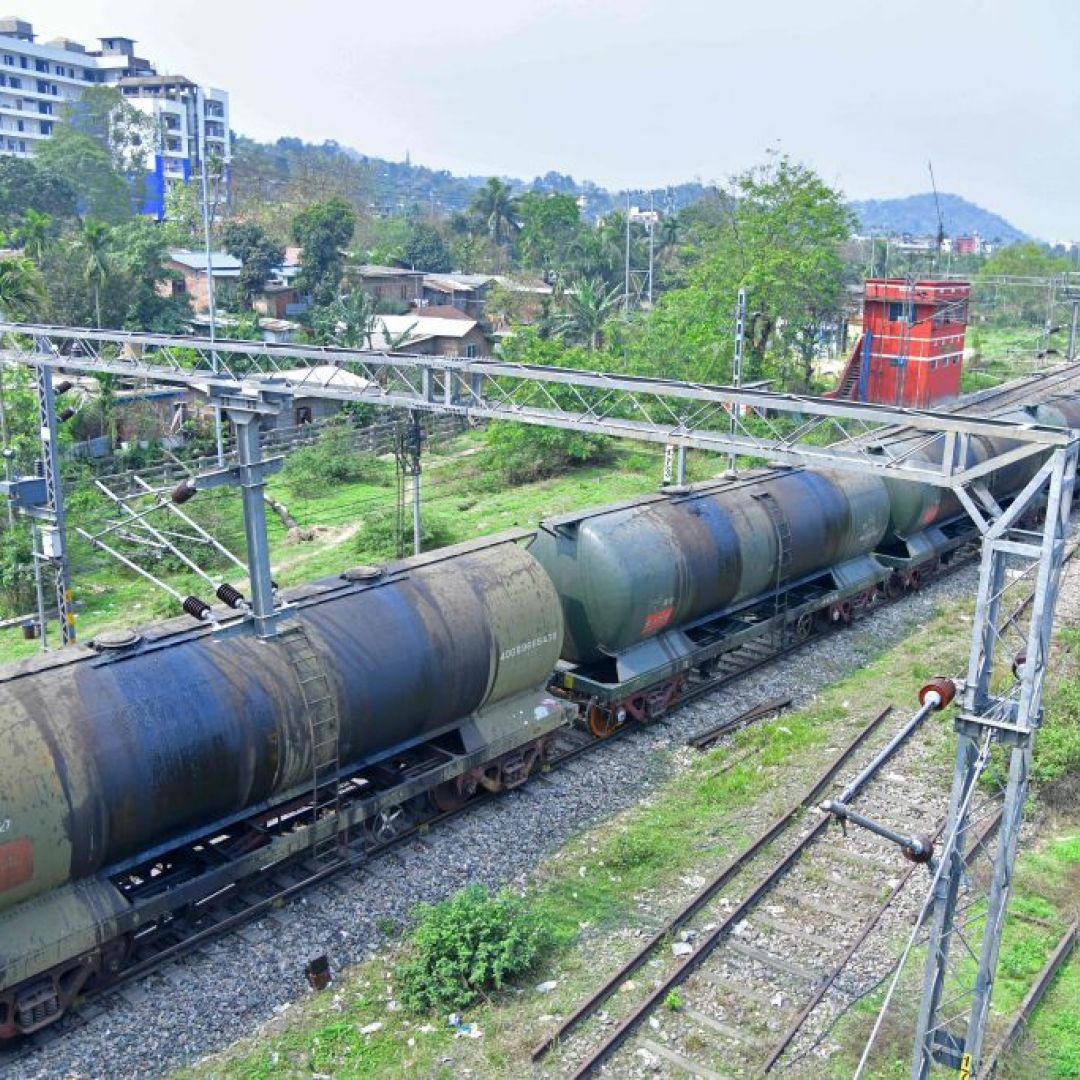 An oil tanker train passes near a refinery in Guwahati, India, on March 30, 2023. An oil tanker train passes near a refinery in Guwahati, India, on March 30, 2023.
