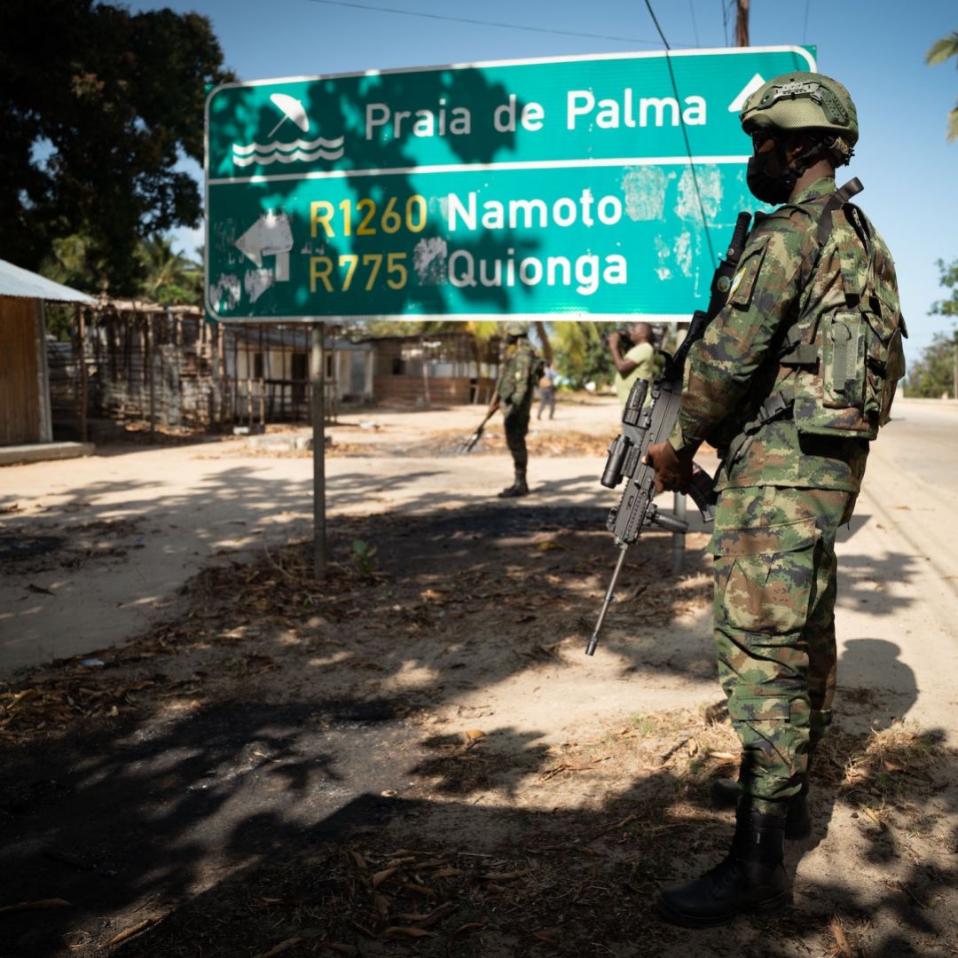 A Rwandan soldier walks in front of a burned truck near Palma in Mozambique’s Cabo Delgado region on Sept. 22, 2021. 