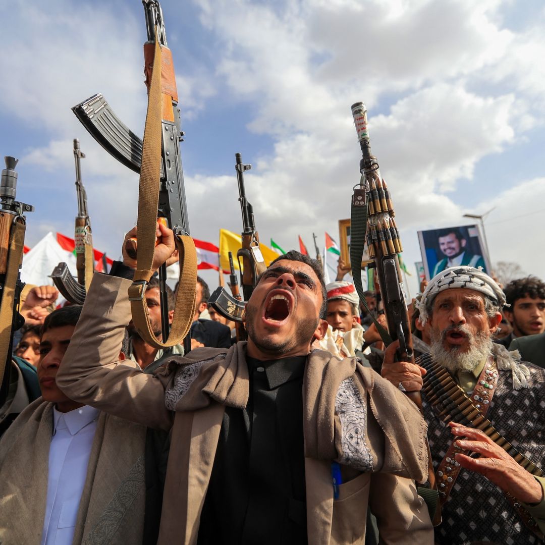Armed Yemeni supporters of the Iran-backed Houthi movement brandish their weapons during a protest against U.S. strikes on Iran in Sanaa on July 10, 2026. Armed Yemeni supporters of the Iran-backed Houthi movement brandish their weapons during a protest against U.S. strikes on Iran in Sanaa on July 10, 2026.