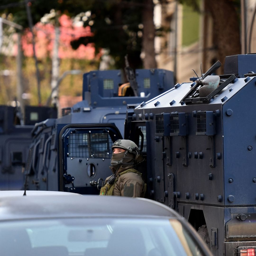 Authorities search a building in Mitrovica, northern Kosovo, on Sept. 29, 2023, after the killing of a police officer.