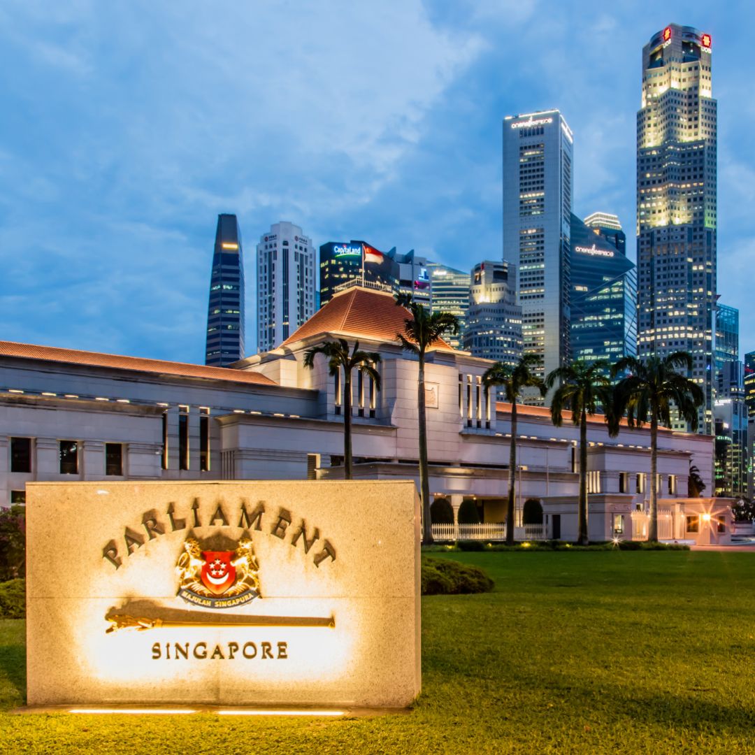 A photo of Singapore's Parliament building against a cityscape.