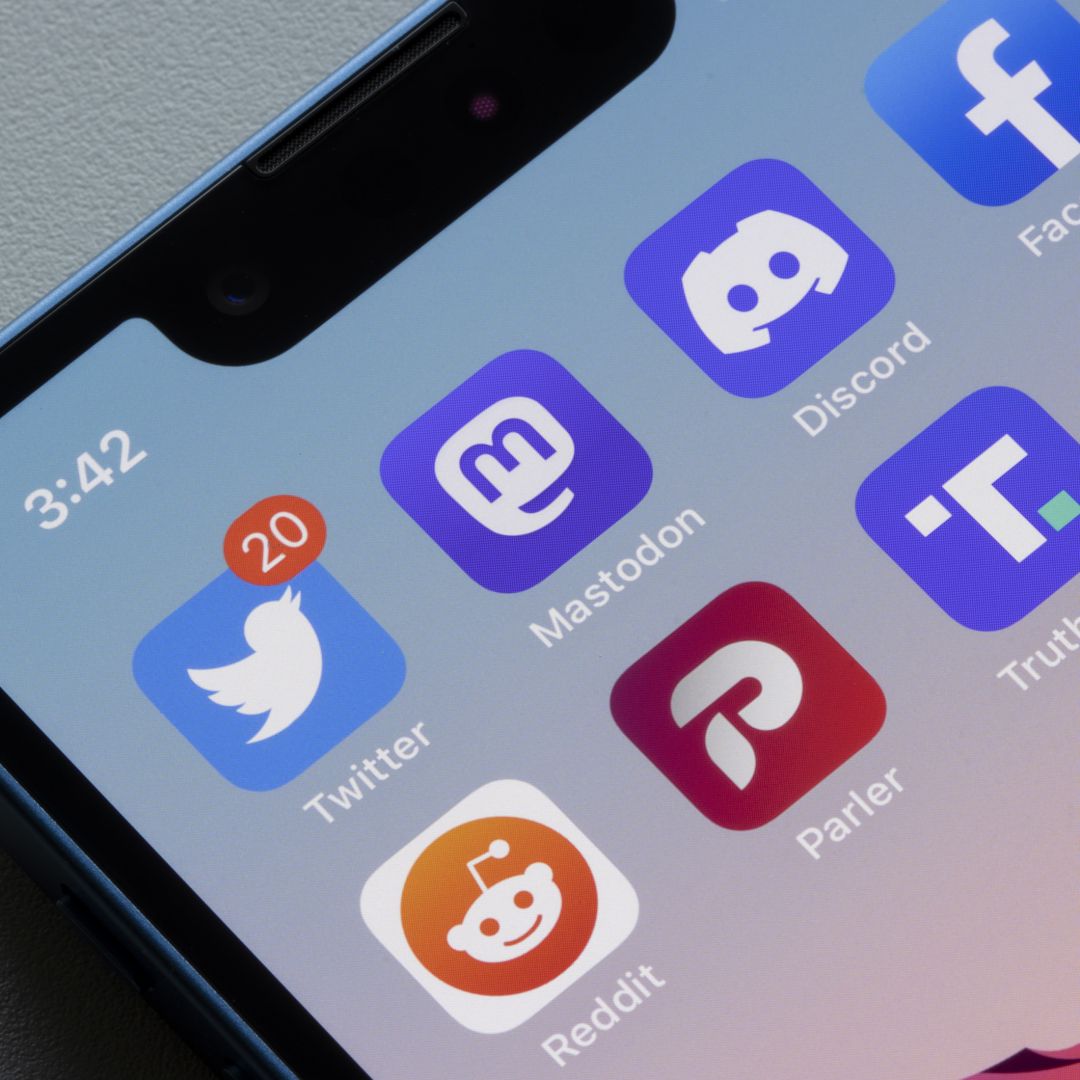 App icons of social media platforms Twitter, Mastodon, Discord, Facebook, Reddit, Parler and Truth Social, are seen on an iPhone. 