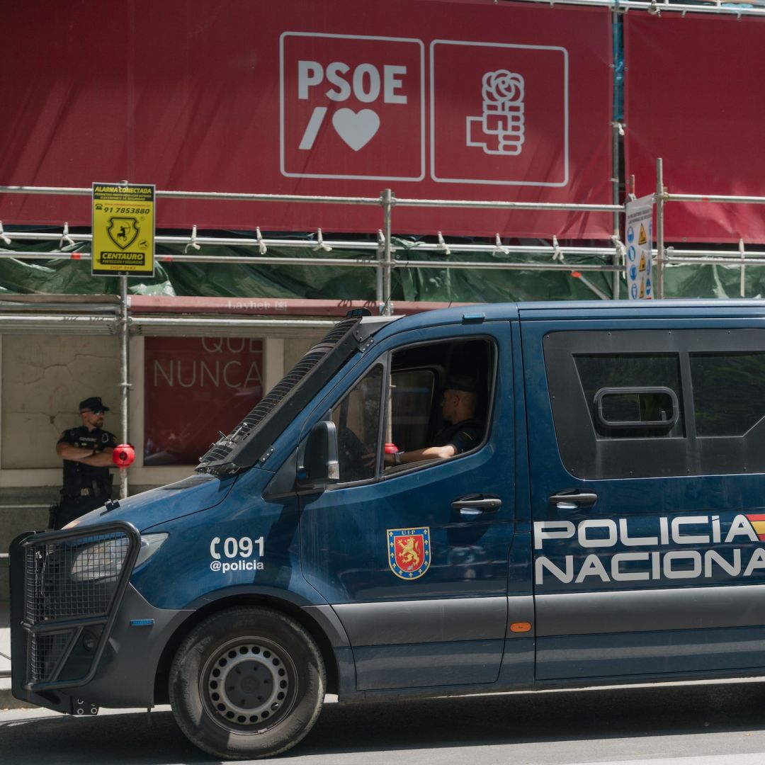 A National Police van is parked in front of the Spanish Socialist Workers' Party headquarters during the Civil Guard's police search on May 27, 2026, in Madrid, Spain. 