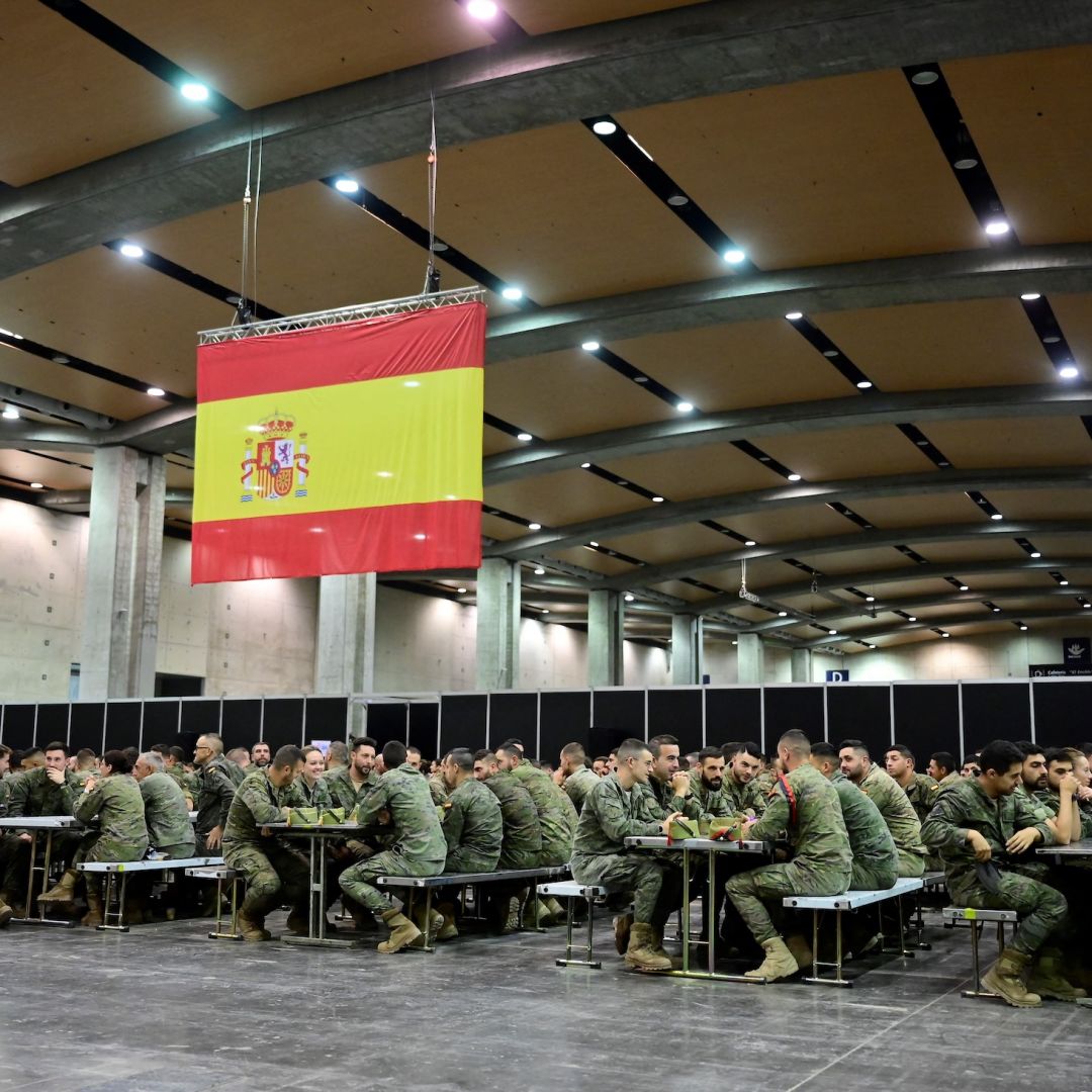 Spanish soldiers sit at tables at a makeshift military base in Valencia, eastern Spain, on Nov. 12, 2024, following deadly floods in the region.