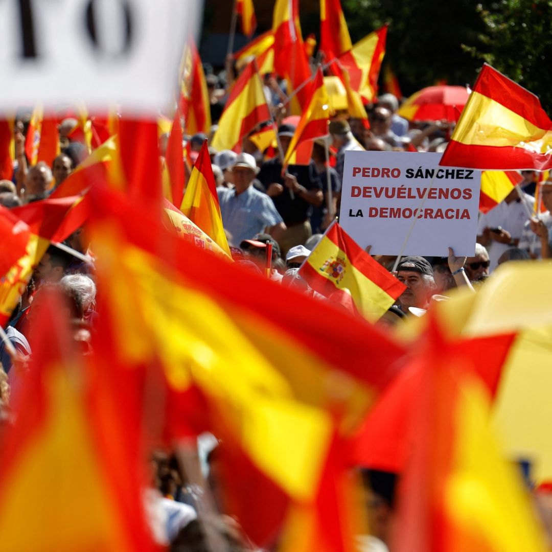 A protester holds a sign reading "Pedro Sanchez, give us back the democracy" during a demonstration in Madrid against Spanish Prime Minister Pedro Sanchez's government on June 8, 2025. A protester holds a sign reading "Pedro Sanchez, give us back the democracy" during a demonstration in Madrid against Spanish Prime Minister Pedro Sanchez's government on June 8, 2025.