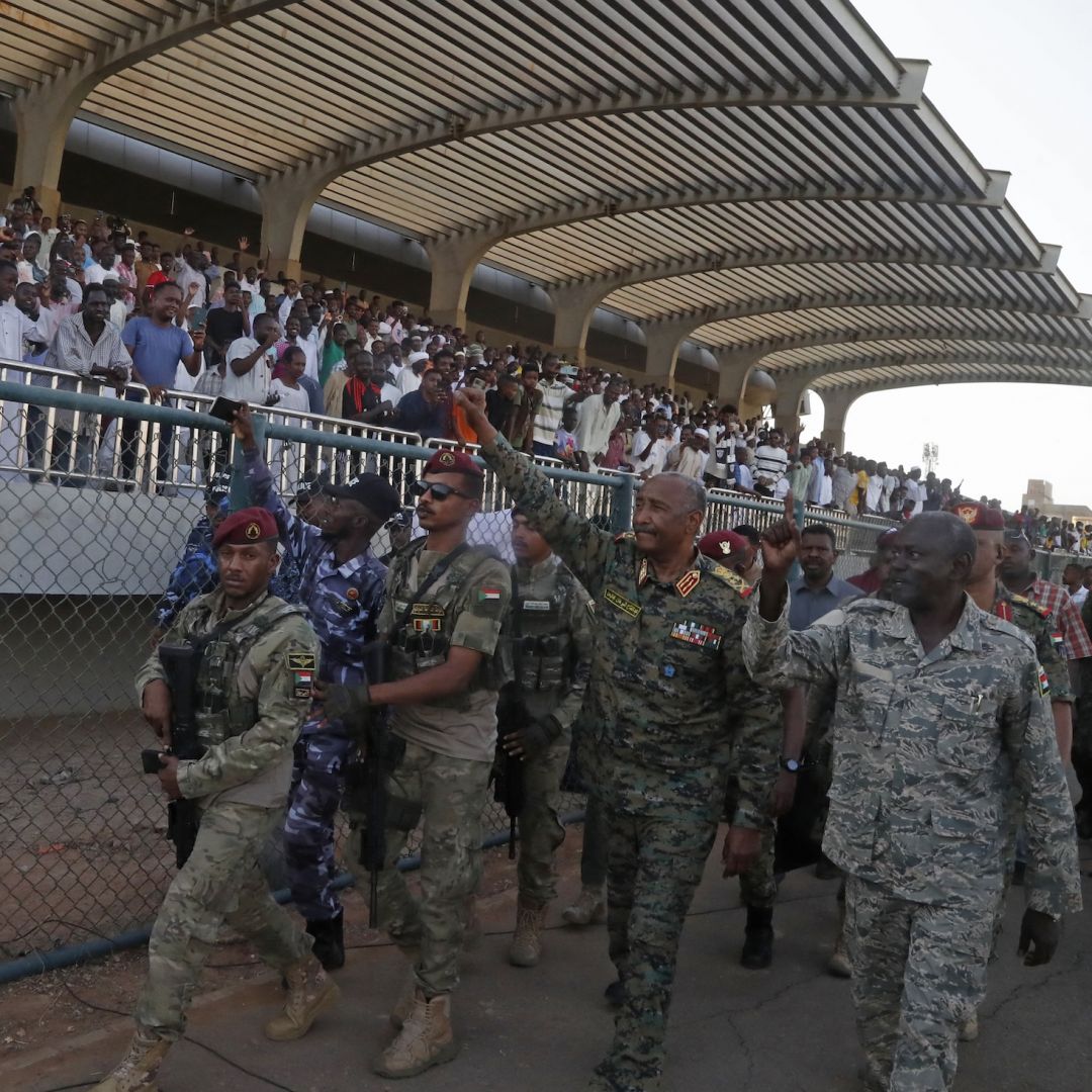 Sudan's de facto leader and army chief, Abdel Fattah al-Burhan, waves to spectators after attending a soccer match at Kober Stadium in Khartoum on May 15, 2026.