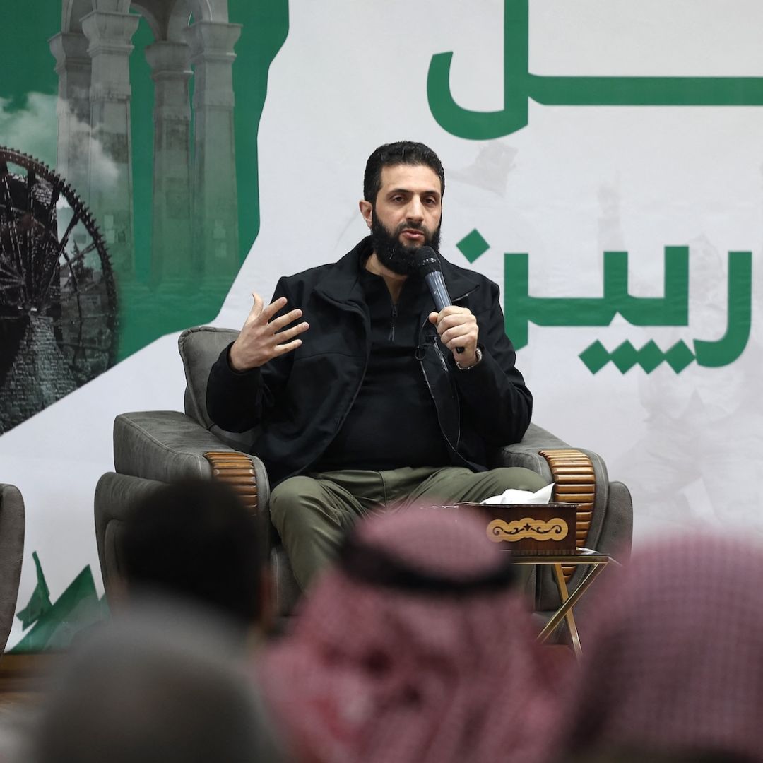 Abu Mohammed al-Golani (C), the head of Syria's leading insurgent group Hayat Tahrir al-Sham, speaks during a press conference near Syria's northern Bab al Hawa border crossing with Turkey late on March 12, 2024.