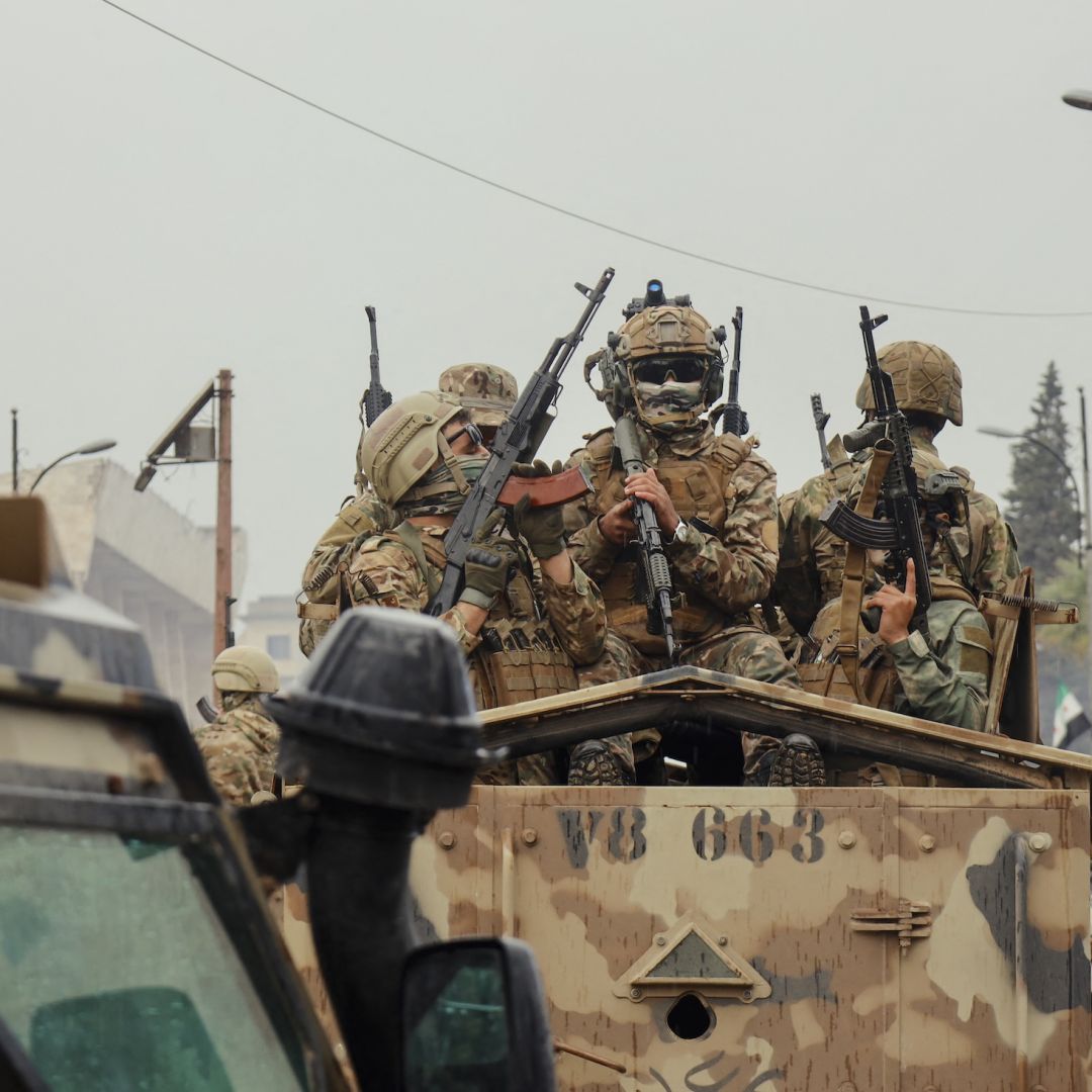 Soldiers ride atop an armored vehicle during a military parade in Idlib, Syria, on Dec. 8, 2025. Soldiers ride atop an armored vehicle during a military parade in Idlib, Syria, on Dec. 8, 2025.