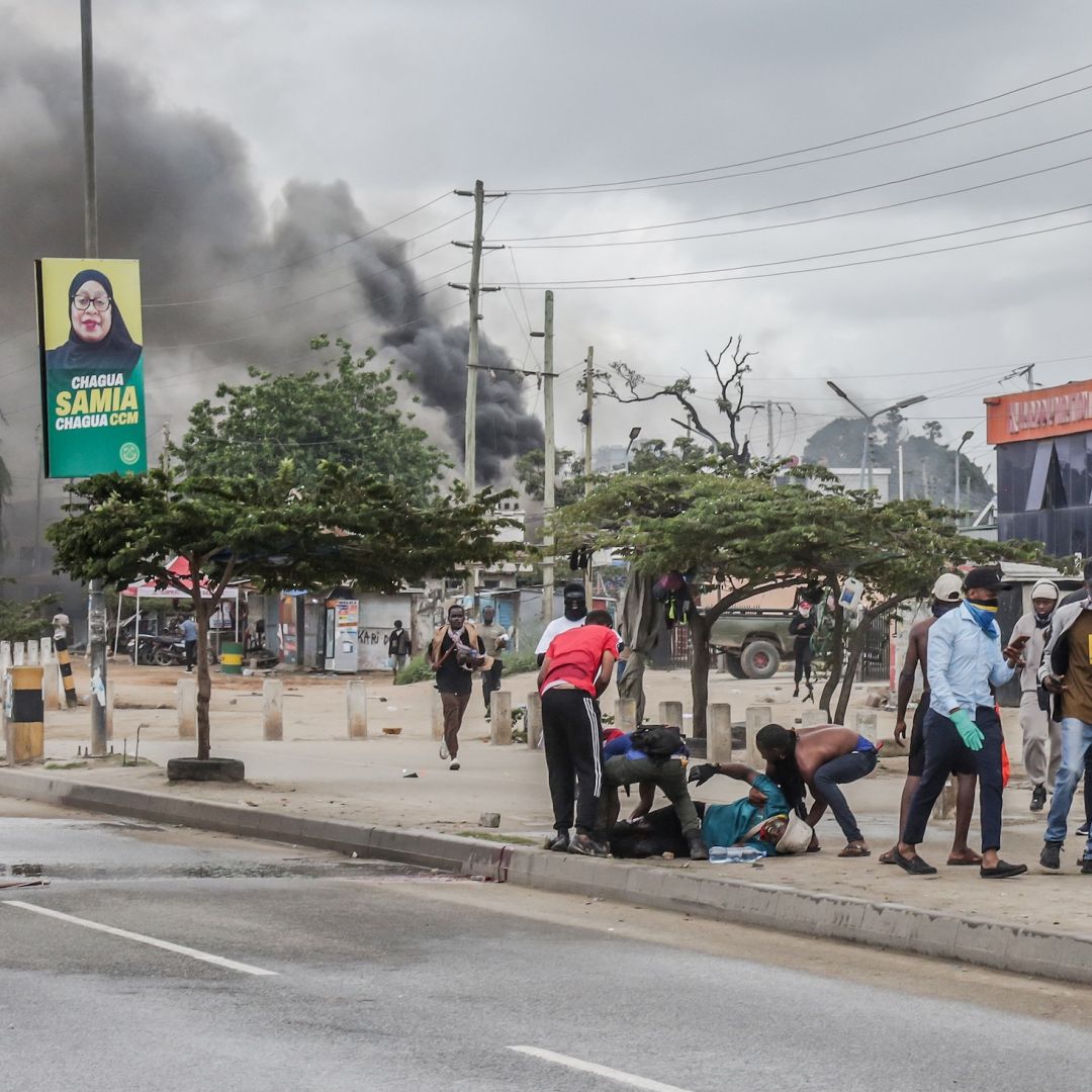 Protesters help an injured demonstrator near burning barricades amid clashes in Dar es Salaam, Tanzania, on Oct. 29, 2025. Protesters help an injured demonstrator near burning barricades amid clashes in Dar es Salaam, Tanzania, on Oct. 29, 2025.