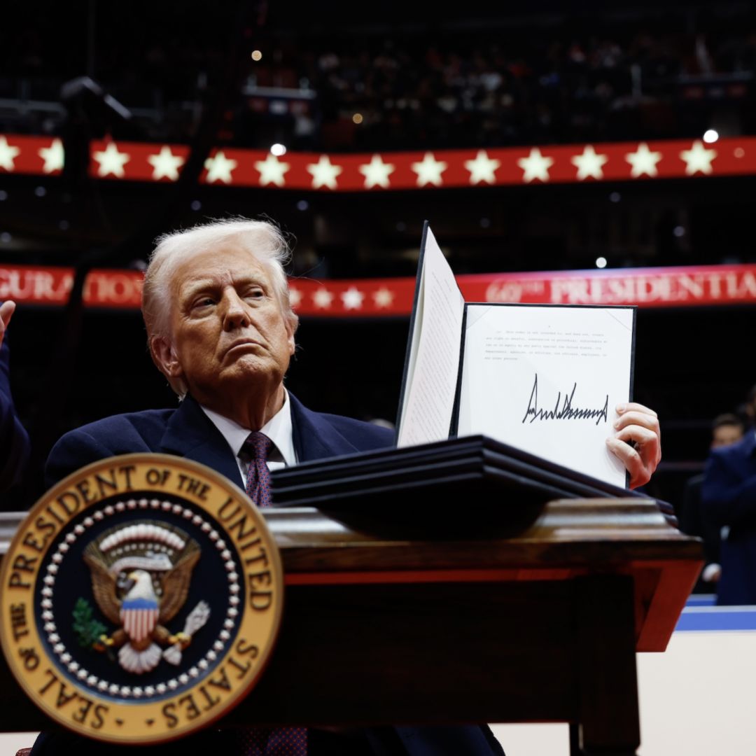 U.S. President Donald Trump holds up an executive order after signing it during an indoor inauguration parade at the Capital One Arena in Washington, D.C, on Jan. 20, 2025.