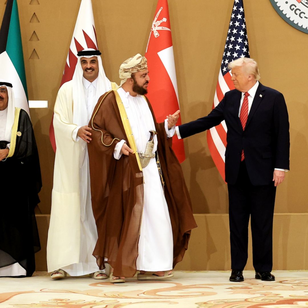 U.S. President Donald Trump (right) interacts with Oman Deputy Prime Minister Sayyid Asaad (second from right) as they prepare to pose for photos with leaders during the Gulf Cooperation Council (GCC) Leaders' Summit in Riyadh, Saudi Arabia, on May 14, 2025.