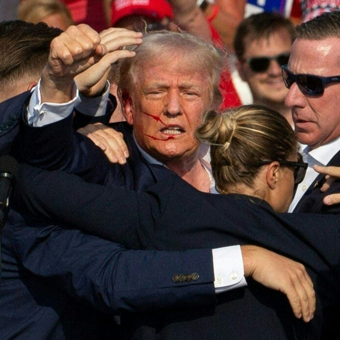 Republican presidential candidate Donald Trump with blood on his face surrounded by secret service agents as he is taken off the stage at a July 13 campaign event in Butler, Pennsylvania.