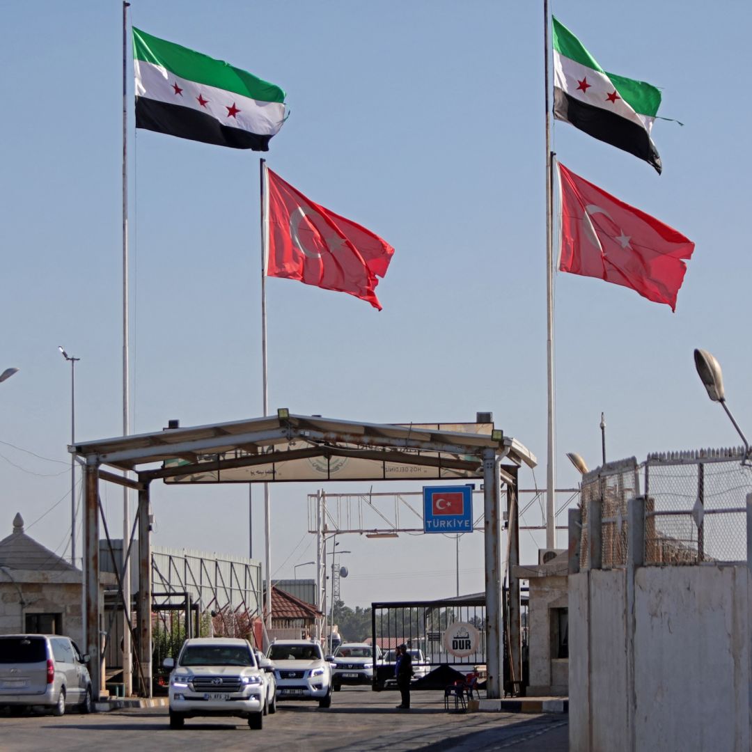 Turkish and Syrian flags wave above Syria's al-Salameh border crossing with Turkey on Aug. 27, 2023. 