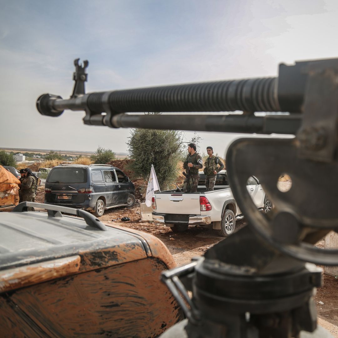 This photo shows fighters with the Turkish-backed Syrian National Army gathered near the Turkish border in northeastern Syria on Oct. 11, 2019.