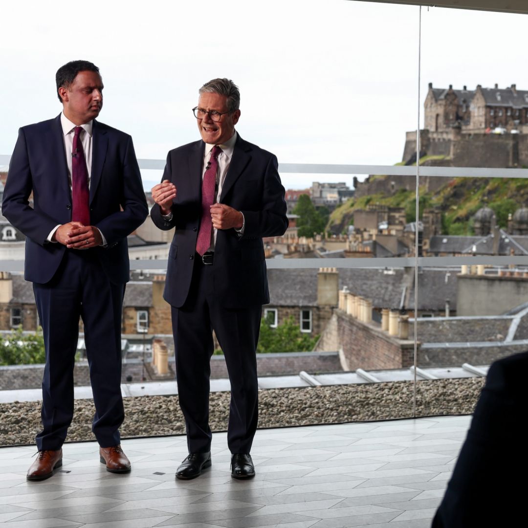 Labour leader and Prime Minister Sir Keir Starmer (R) speaks with Scottish Labour leader Anas Sarwar (L) on July 07, 2024 in Edinburgh, Scotland. 