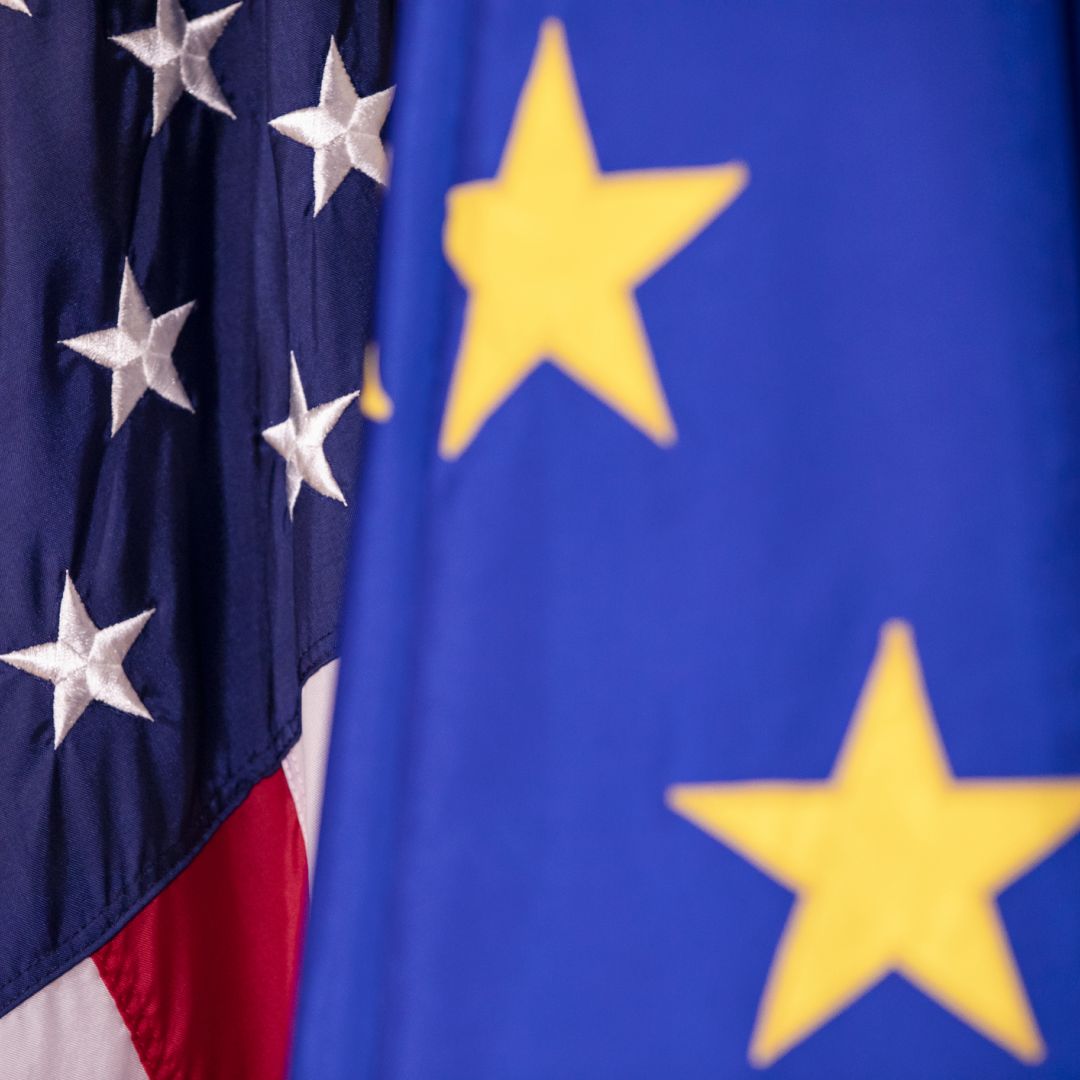 The U.S. and EU flags are seen next to each other.