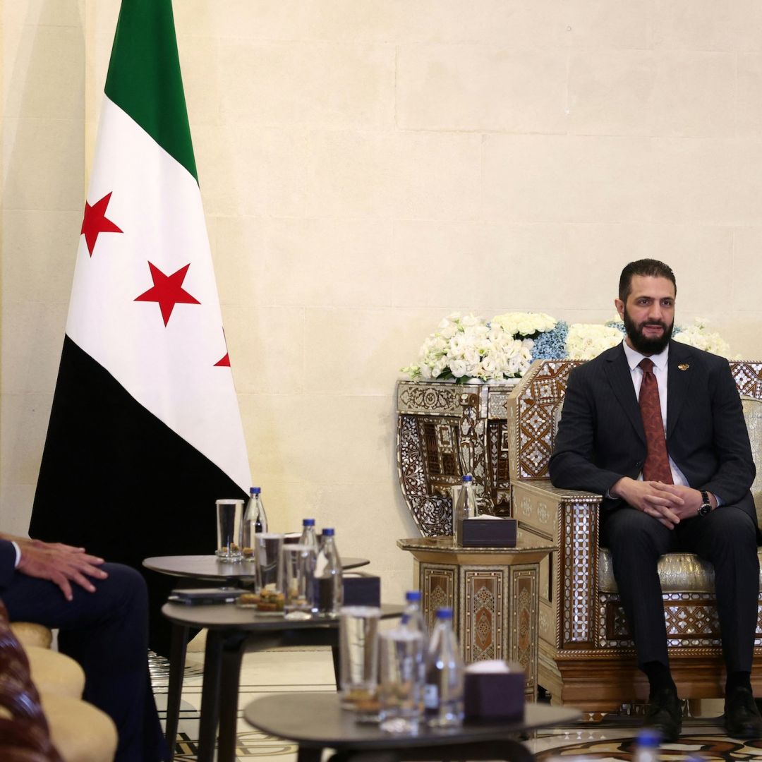 Syria's interim President Ahmad al-Sharaa (right) meets with U.S. envoy to Syria, Tom Barrack, at the presidential palace in Damascus on July 9, 2025. 