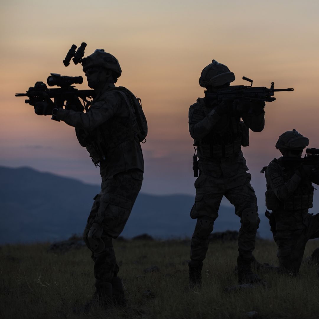 A stock image shows the silhouettes of soldiers.