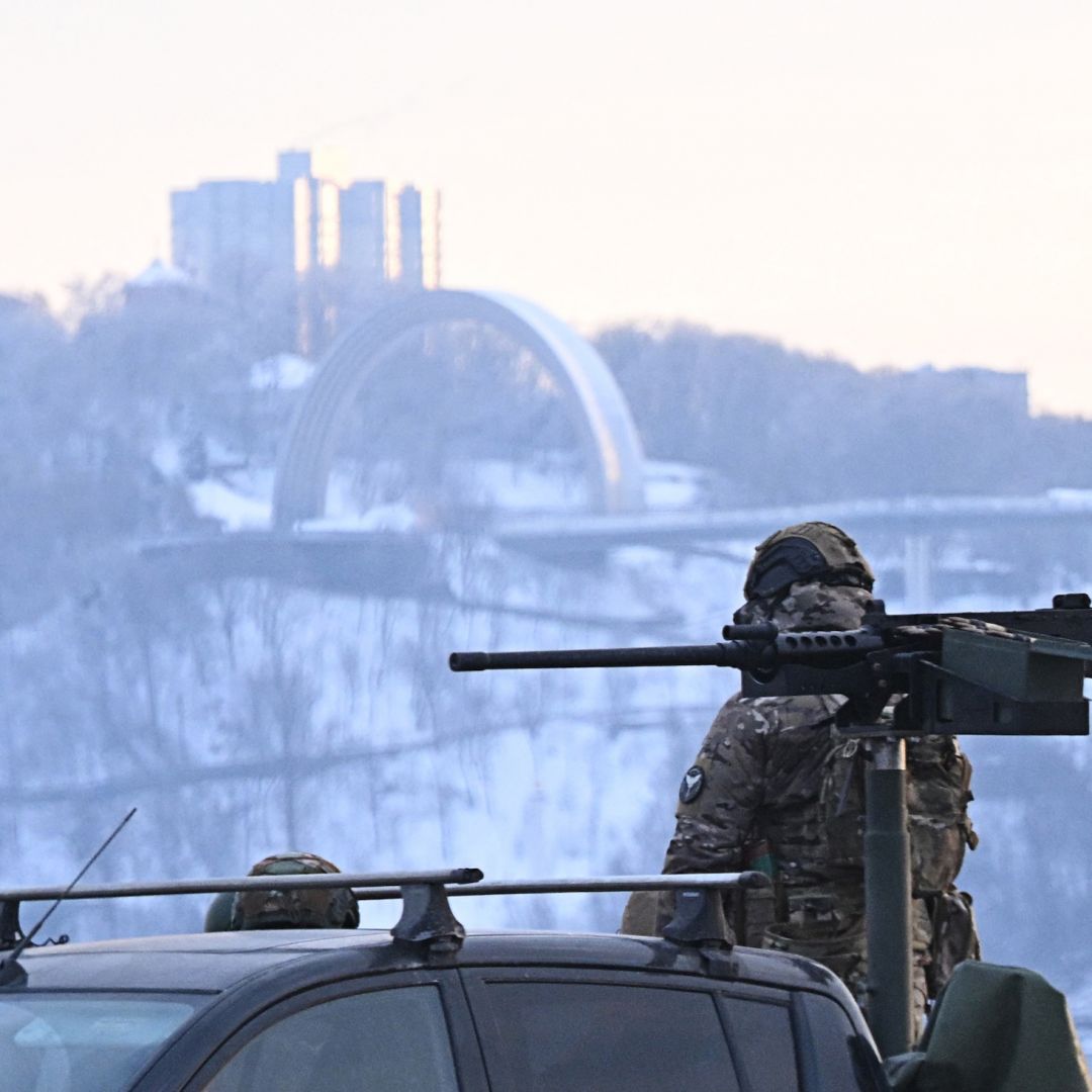 A Ukrainian serviceman stands next to a truck equipped with a machine gun during an air raid alert in Kyiv on Jan. 24, 2026, amid Russia’s ongoing invasion.