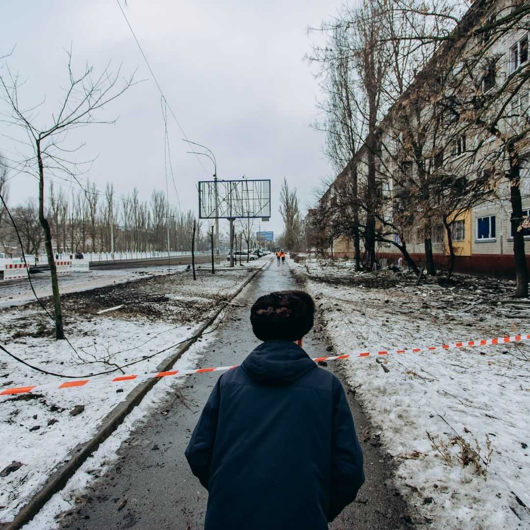 A man looks at the road blocked by striped tape on December 13, 2023, in Kyiv, Ukraine, following two nights of ballistic missile attacks on the city.