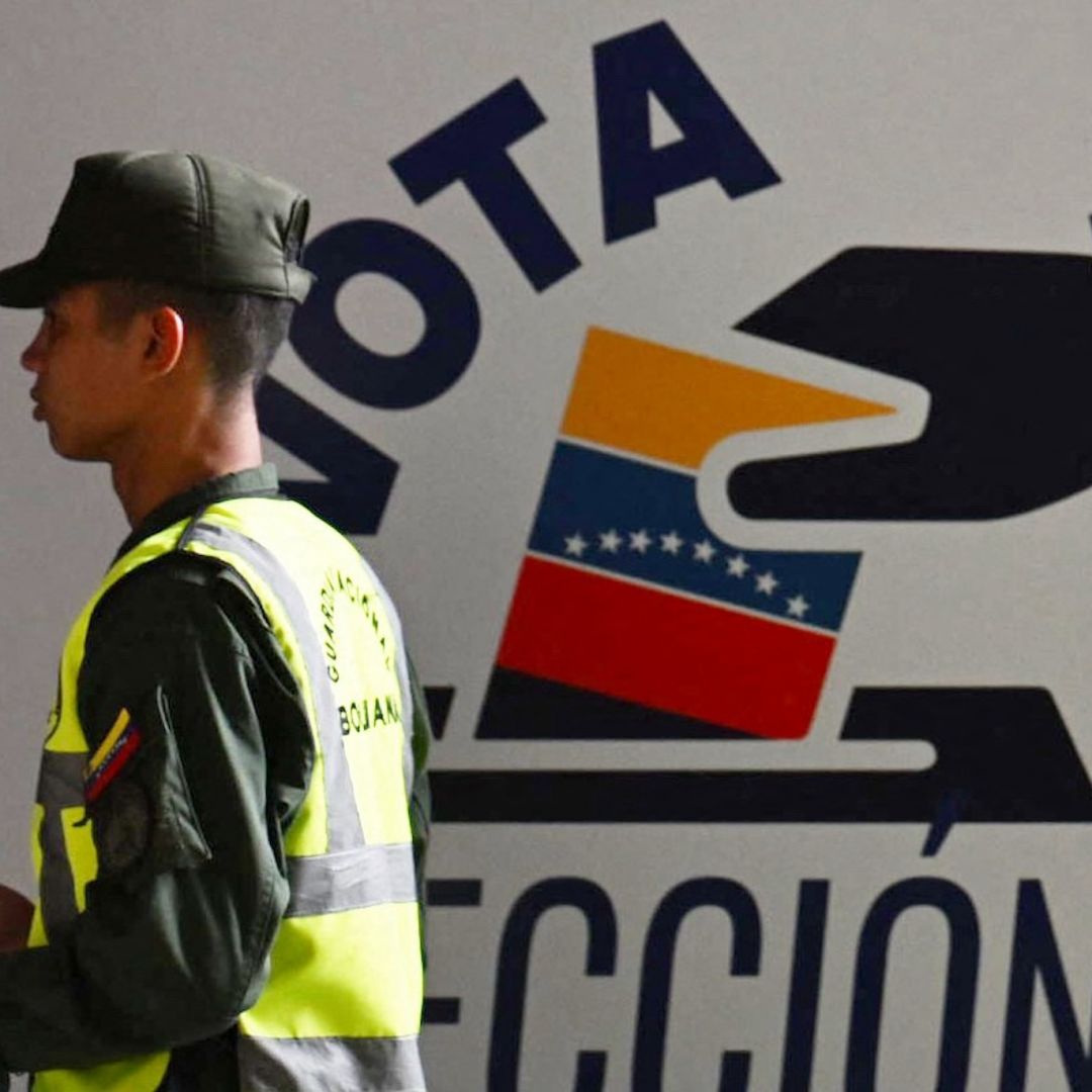 A member of Venezuela’s national guard walks past the information center of the country’s National Electoral Council (CNE) in Caracas on July 16, 2024, ahead of the upcoming presidential election.