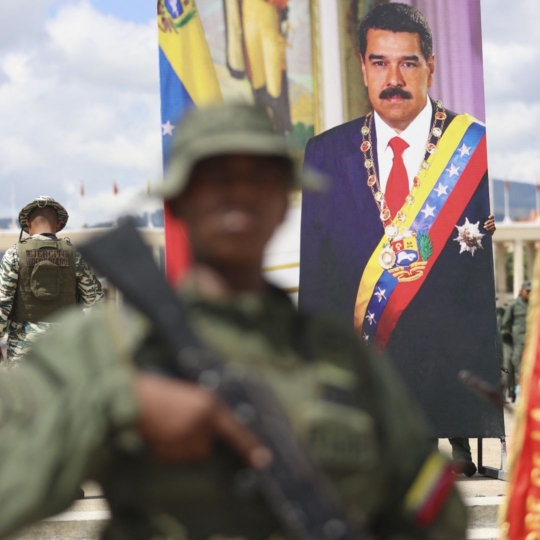 A poster displaying a photo of Venezuelan President Nicolas Maduro is seen as members of the Bolivarian Armed Forces take part in a military exercise in Caracas on Sept. 20, 2025. 