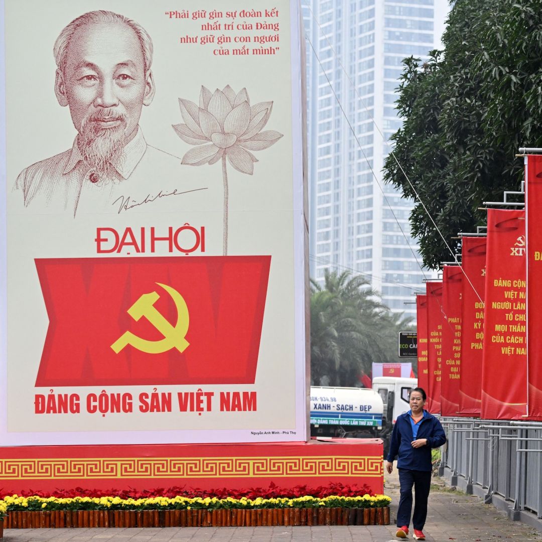 A man walks past a billboard for the 14th Congress of the Communist Party of Vietnam outside the National Convention Center in Hanoi on Jan. 15, 2026. 