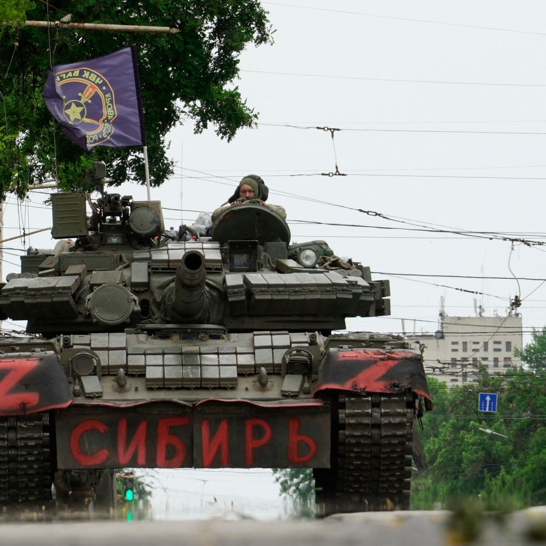 Members of Wagner Group on June 24, 2023, sit on a tank in a street in the city of Rostov-on-Don.