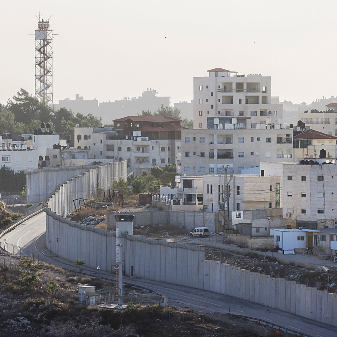 A photo taken on Nov. 4, 2023, shows a wall dividing the West Bank (right) from Israeli settlements (left) in Al-Ram, West Bank.