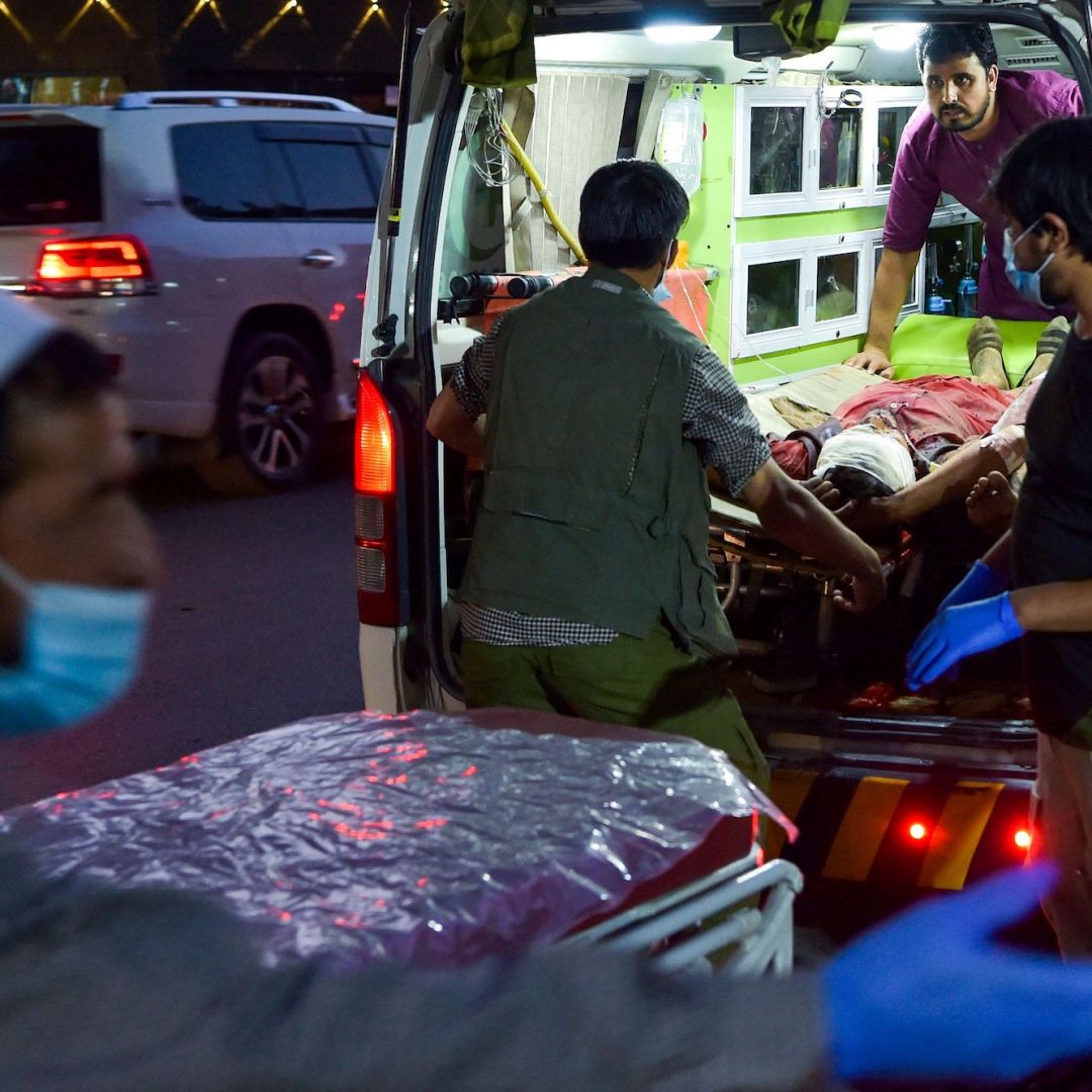Medical staff bring an injured man to a hospital after a deadly militant attack Aug. 26, 2021, outside Hamid Karzai International Airport in the Afghan capital of Kabul.