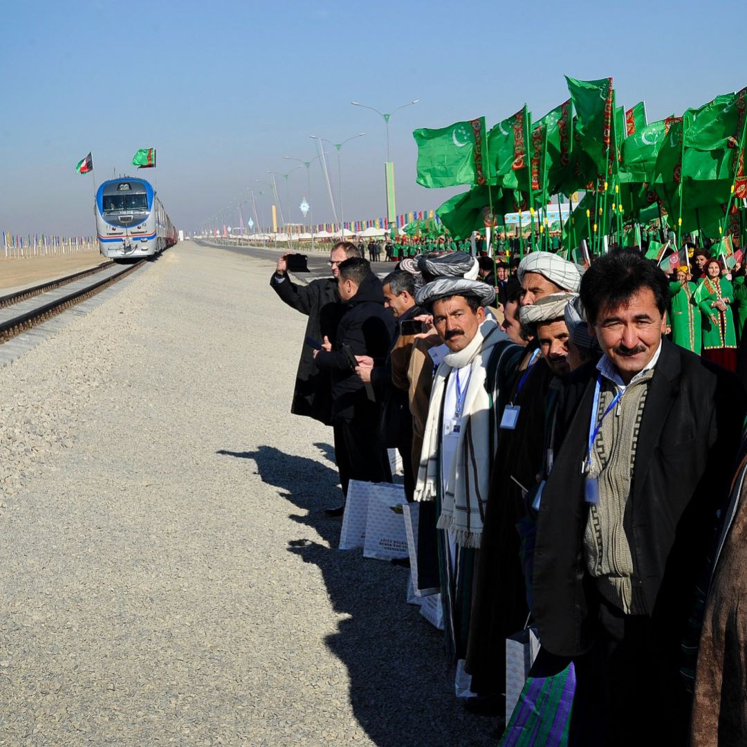 People gather at the Imamnazar customs point during a ceremony for the opening of the first section of a $2 billion railway link between Turkmenistan and Afghanistan.