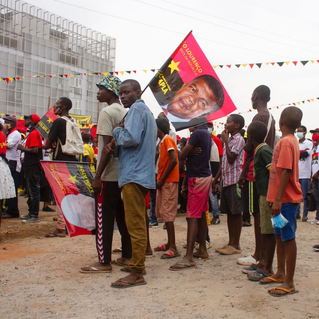 Angolan President Joao Lourenco is pictured on a flag at a campaign rally for the country’s ruling People's Movement for the Liberation of Angola (MPLA) party on June 26, 2021, at Largo das Escolas in Luanda. 