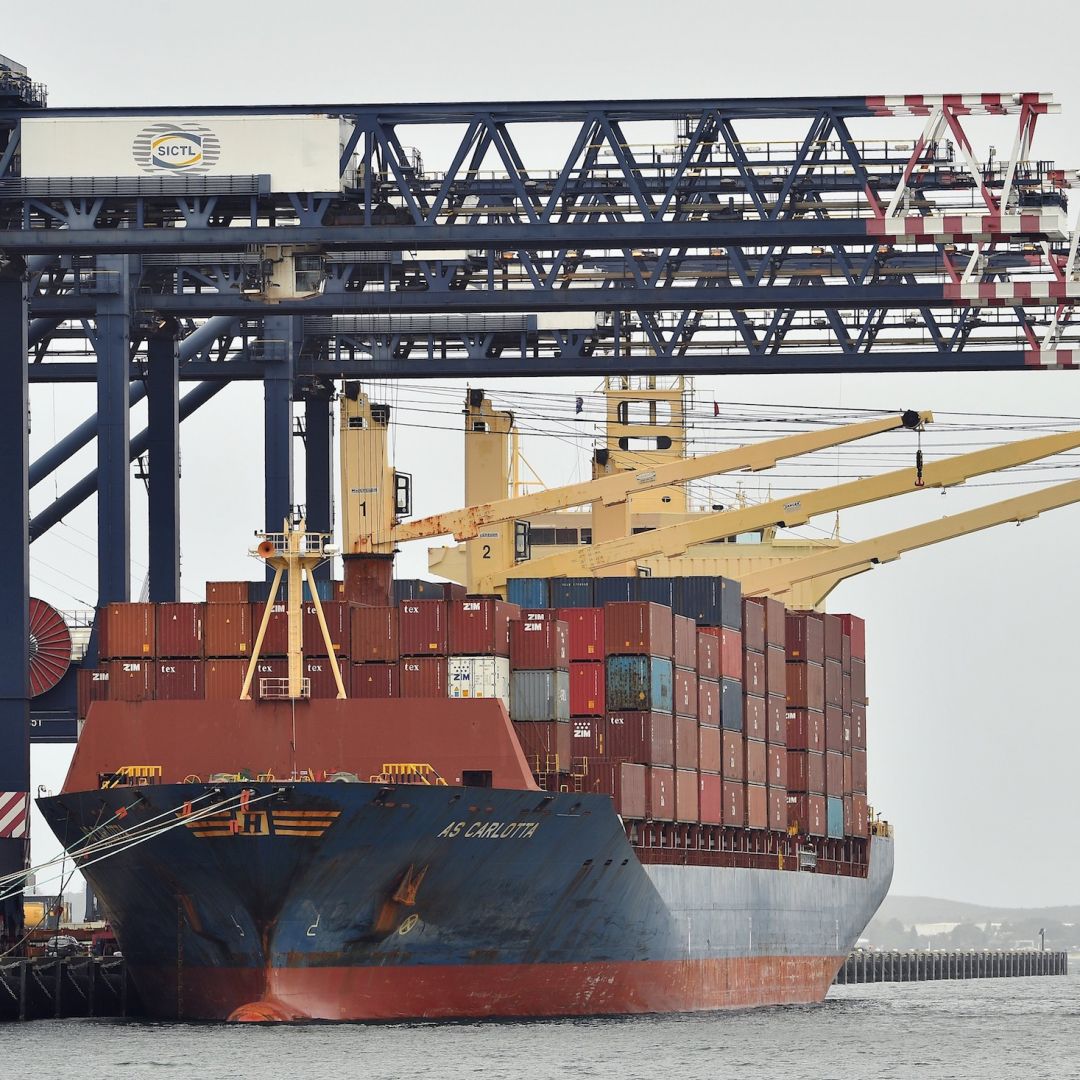 Workers load containers on a cargo ship at Port Botany in Sydney, Australia, on Dec. 2, 2020. 