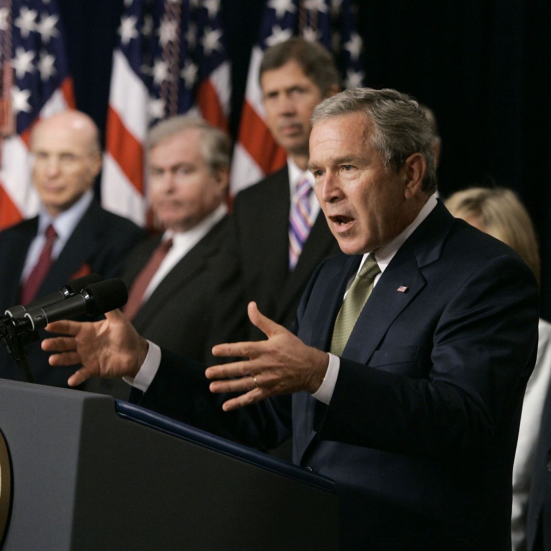 In this 2005 file photo, former U.S. President George W. Bush talks about the Central America-Dominican Republic Free Trade Agreement in Washington, joined by former Cabinet officials who supported the trade deal.