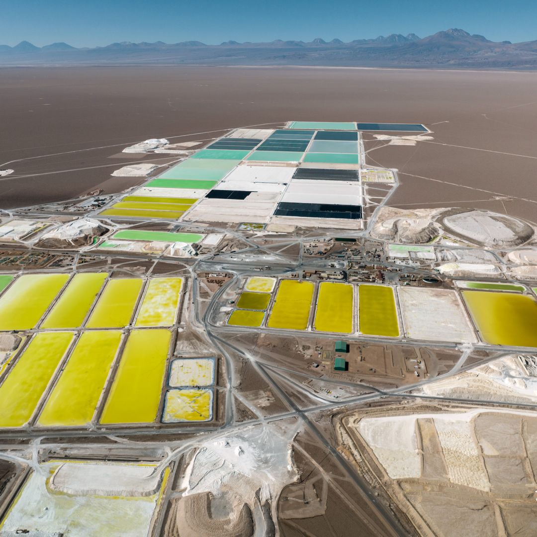 In this aerial view, pools of brine containing lithium carbonate and mounds of salt byproduct stretch through a lithium mine in the Atacama desert on Aug. 24, 2022, in Salar de Atacama, Chile.