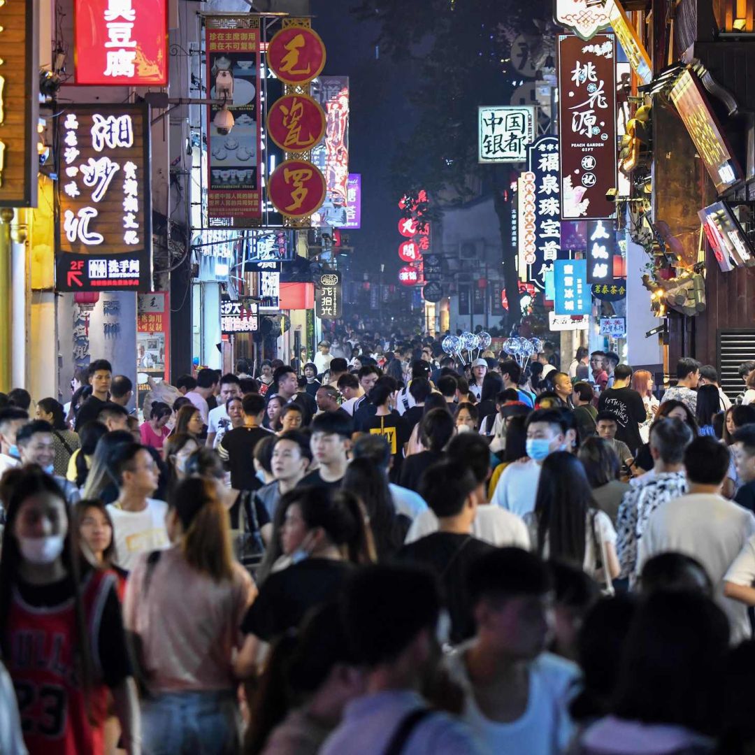 People walk along a pedestrian street surrounded by small shops in Changsha, China, on Sept. 7, 2020.