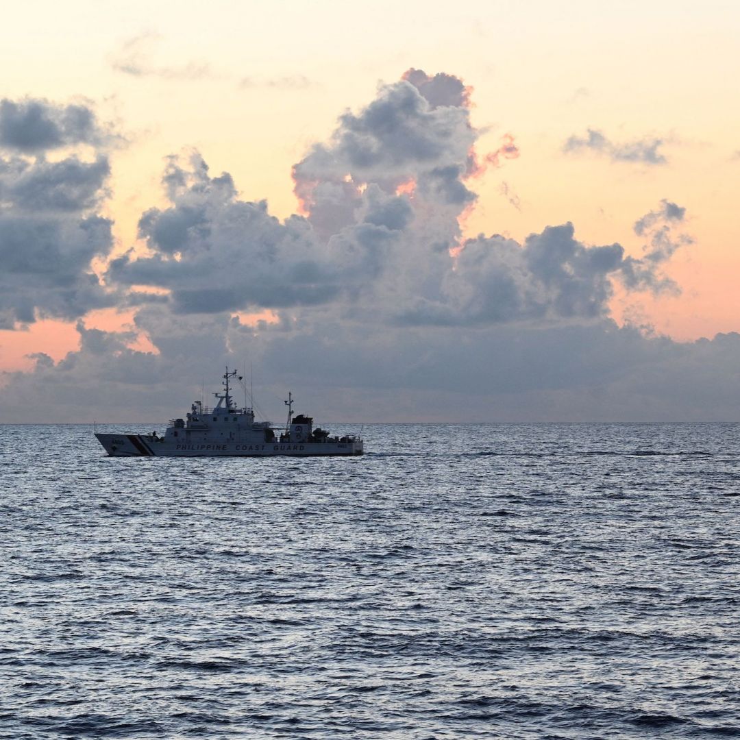 A Chinese coast guard ship (R) shadows the Philippine coast guard vessel BRP Malapascua (L) while on patrol at the Second Thomas Shoal in the Spratly Islands in the disputed South China Sea on April 23, 2023.