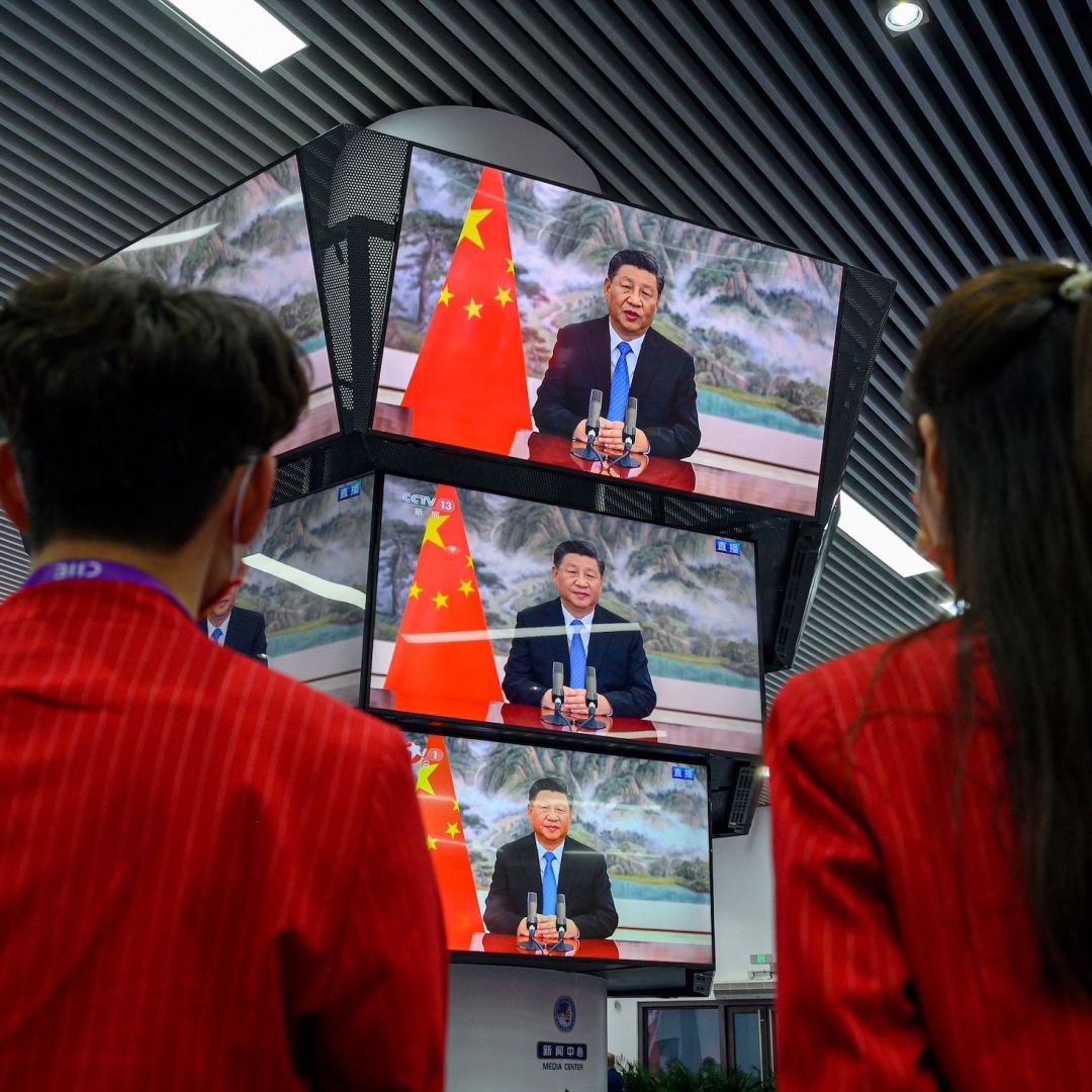 People watch Chinese President Xi Jinping speak during the opening ceremony of the China International Import Expo on Nov. 4, 2021, in Shanghai.