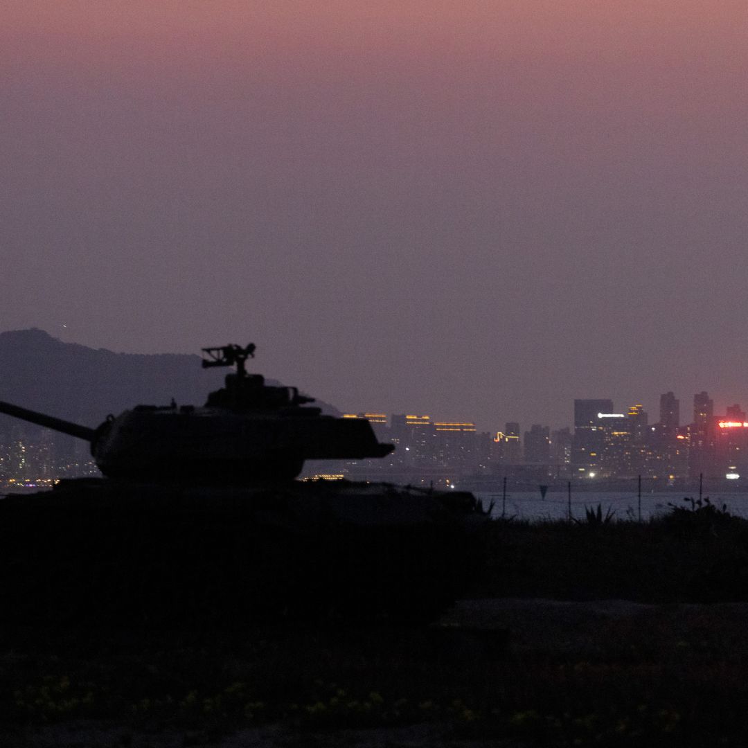 A Taiwanese tank on display for tourists is seen silhouetted against the skyline of the Chinese city Xiamen in Kinmen, Taiwan, an island in the Taiwan Strait that is part of Taiwan's territory.
