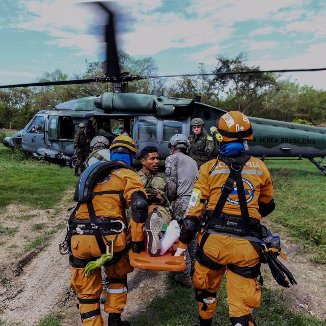 A Colombian rescue crew evacuates a "victim" in a Brazilian air force helicopter during an earthquake simulation exercise conducted by air force members at the Palenquero base in Puerto Salgar, Colombia, on Sept. 6, 2018.